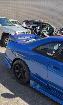 Blue coupe after a full respray, parked outside the Malaga workshop