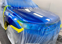 Blue front panel masked with tape ready for spray painting