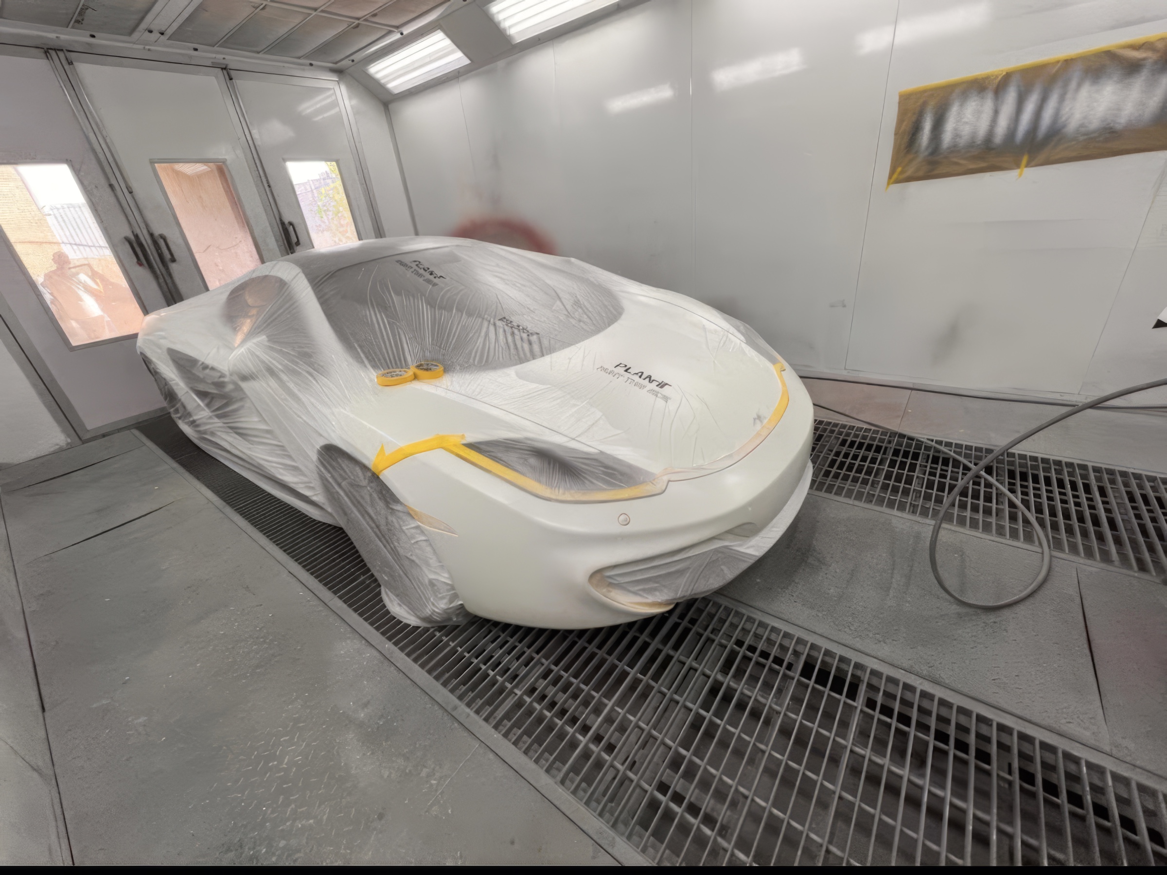 White McLaren in the Malaga spray booth