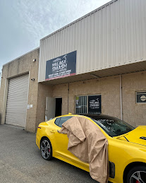 Malaga Smash Repairs workshop on Oxleigh Drive with a yellow car out the front
